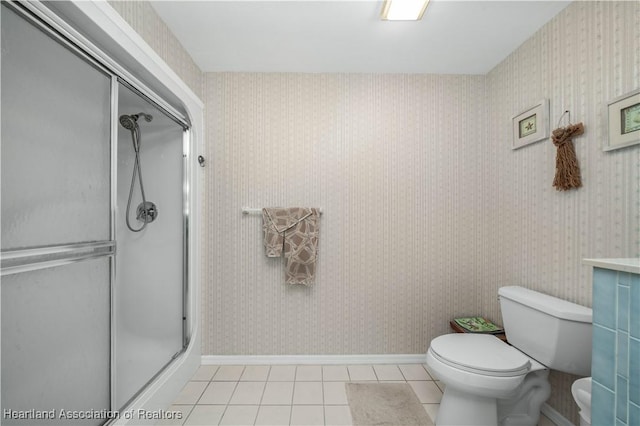 bathroom featuring a shower stall and wallpapered walls