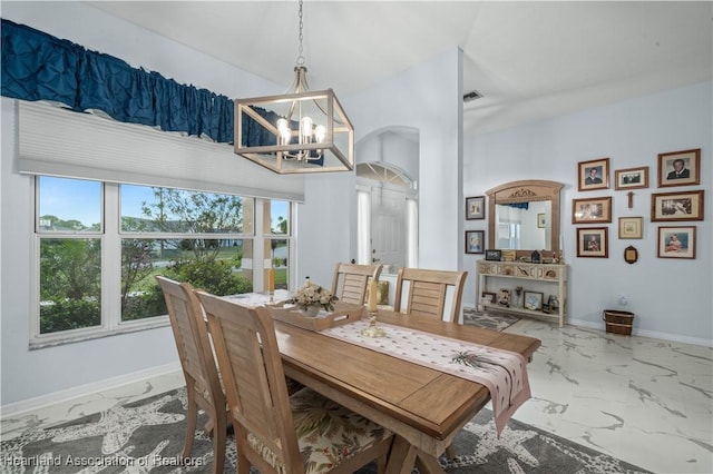 dining space with marble finish floor, visible vents, baseboards, and an inviting chandelier