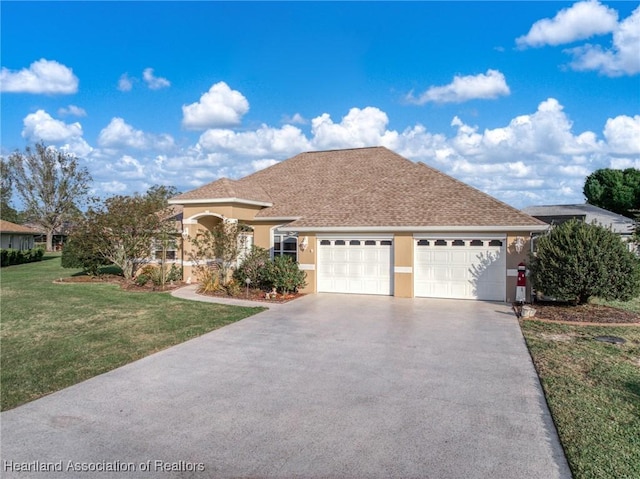 view of front facade featuring a front yard, driveway, an attached garage, and stucco siding