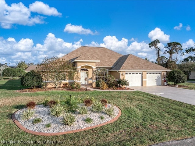 view of front of home with driveway, an attached garage, a front lawn, and stucco siding