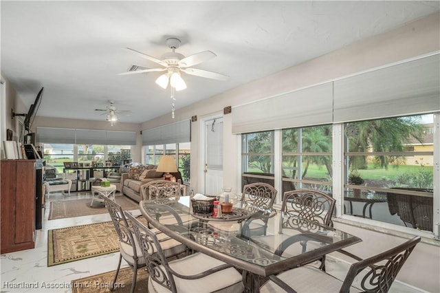 sunroom featuring a ceiling fan