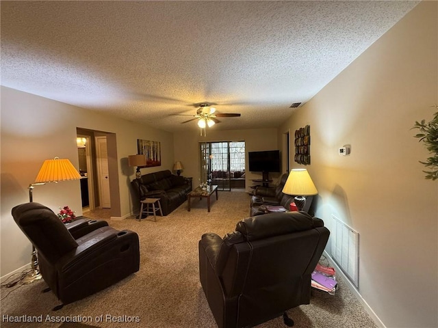 living area featuring carpet floors, a ceiling fan, visible vents, and a textured ceiling