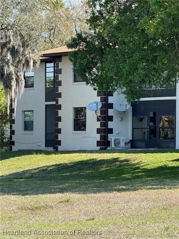 view of property exterior with ac unit, a lawn, and stucco siding