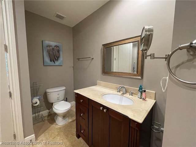 bathroom with tile patterned flooring, vanity, and toilet