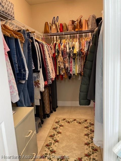 spacious closet with light tile patterned flooring