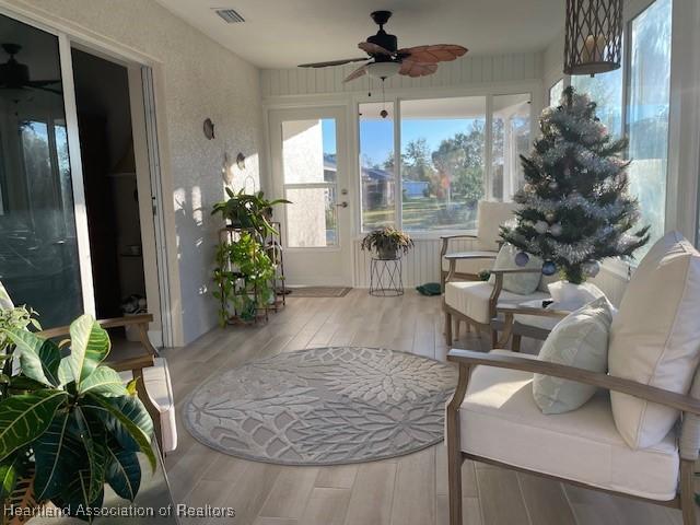 sunroom featuring ceiling fan