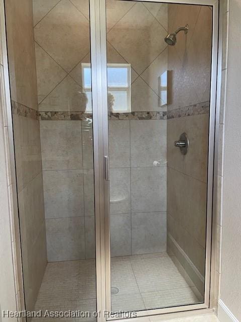 bathroom featuring a shower with door