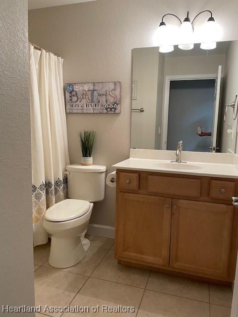 bathroom featuring tile patterned floors, vanity, and toilet