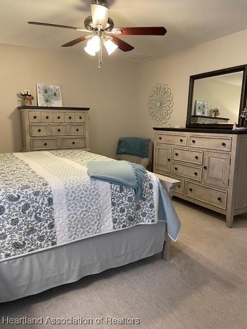 bedroom featuring ceiling fan and light colored carpet