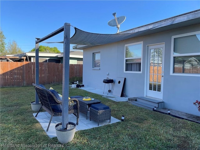 view of yard with a patio area, entry steps, and fence