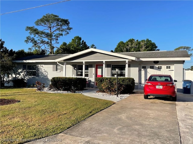 ranch-style home with concrete driveway, a garage, and a front yard