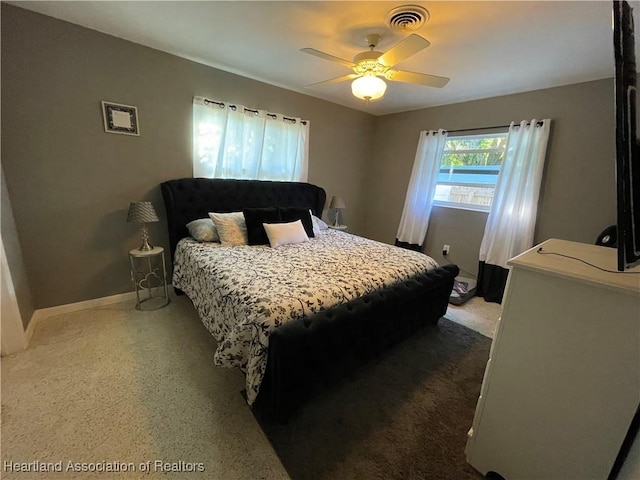 bedroom with speckled floor, baseboards, visible vents, and ceiling fan