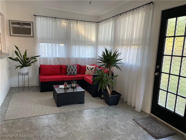 sunroom / solarium featuring a healthy amount of sunlight and a wall mounted air conditioner