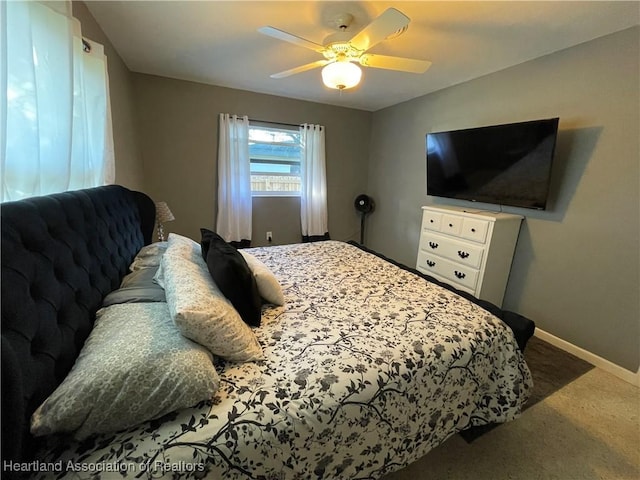 carpeted bedroom with a ceiling fan and baseboards