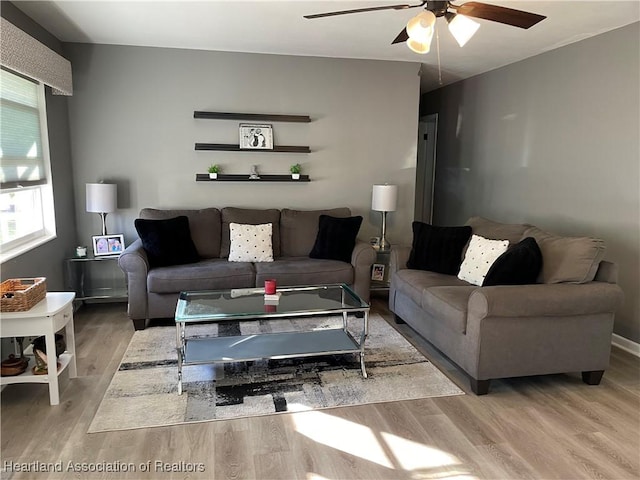 living area with ceiling fan and wood finished floors