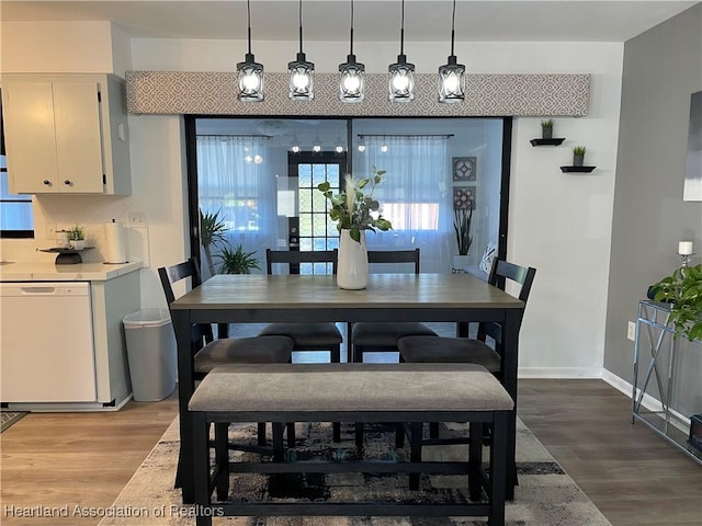 dining space with light wood-style floors and baseboards