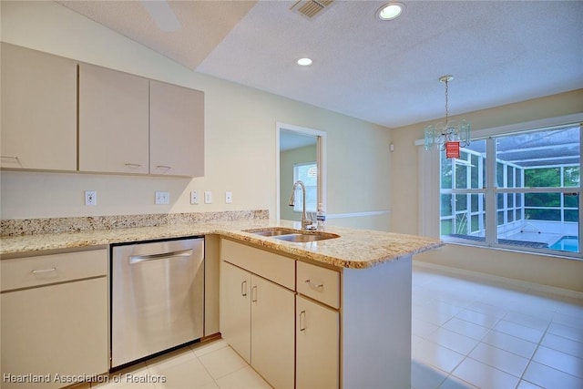 134 Bimini St NE, Lake Placid, FL 33852 - kitchen with dishwasher, a sink, a peninsula, light tile patterned floors, and a textured ceiling