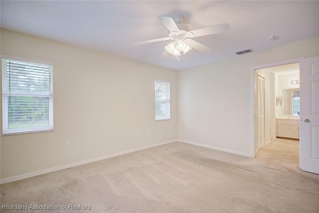 134 Bimini St NE, Lake Placid, FL 33852 - spare room with light colored carpet, baseboards, and a ceiling fan