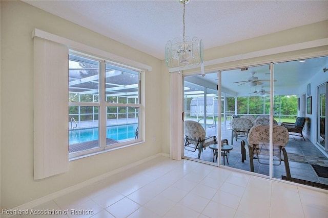 134 Bimini St NE, Lake Placid, FL 33852 - dining space with plenty of natural light, a sunroom, ceiling fan, a chandelier, and a textured ceiling