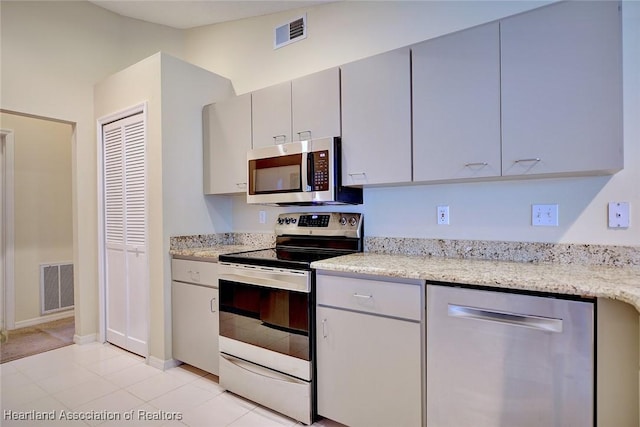 134 Bimini St NE, Lake Placid, FL 33852 - kitchen with stainless steel appliances, baseboards, and light stone countertops
