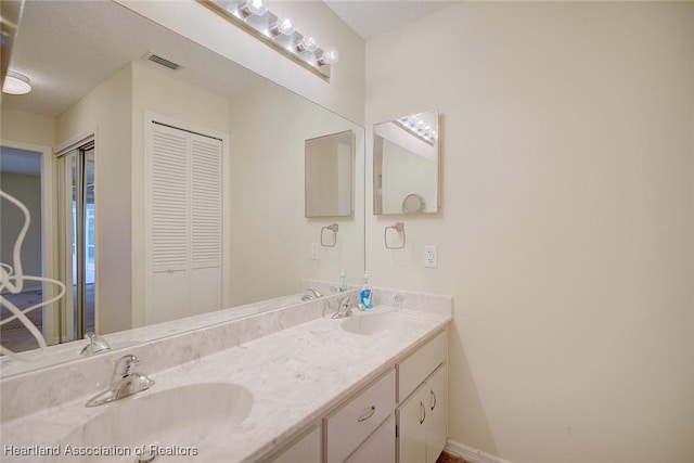 134 Bimini St NE, Lake Placid, FL 33852 - full bath with double vanity, baseboards, and a closet