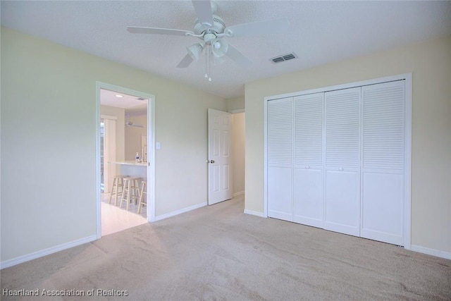 134 Bimini St NE, Lake Placid, FL 33852 - unfurnished bedroom featuring carpet floors, a closet, baseboards, and ceiling fan