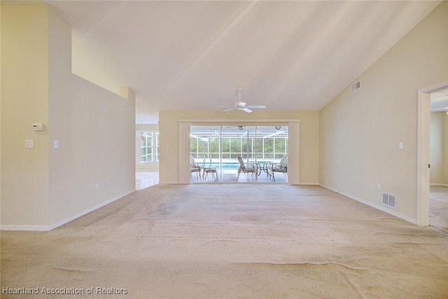 134 Bimini St NE, Lake Placid, FL 33852 - unfurnished living room with lofted ceiling, carpet, baseboards, and ceiling fan