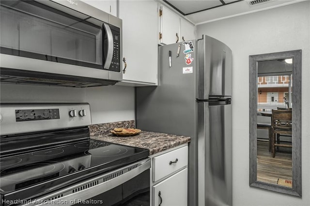 kitchen featuring stainless steel appliances and white cabinetry