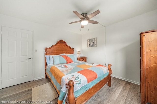 bedroom featuring ceiling fan and wood-type flooring