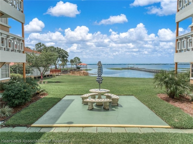 view of yard featuring a patio area and a water view