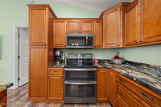 kitchen with crown molding, dark stone counters, hardwood / wood-style flooring, and appliances with stainless steel finishes