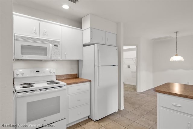 kitchen with white appliances, decorative light fixtures, light tile patterned floors, and white cabinets