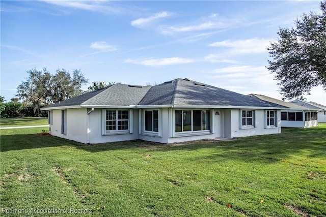 rear view of property with a yard