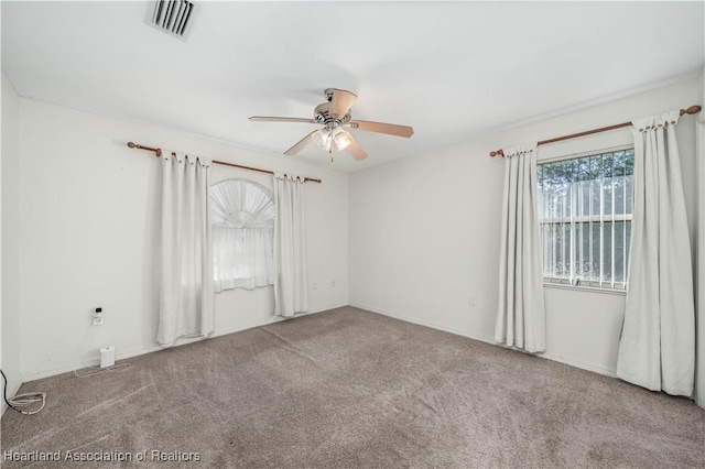 empty room with carpet flooring and ceiling fan