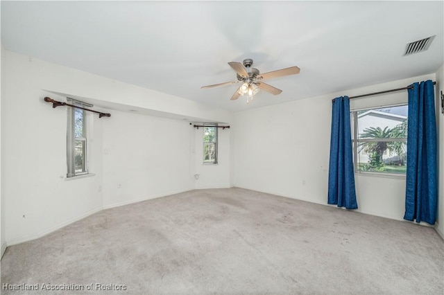 unfurnished room with ceiling fan and carpet floors