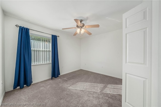 carpeted empty room with ceiling fan