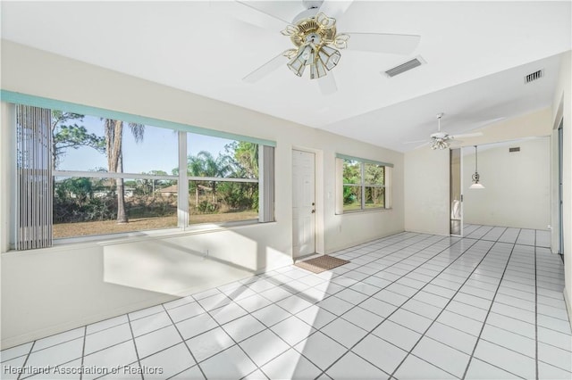 interior space with ceiling fan, light tile patterned flooring, and vaulted ceiling