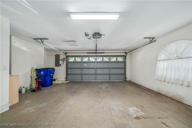 garage featuring a garage door opener and electric panel