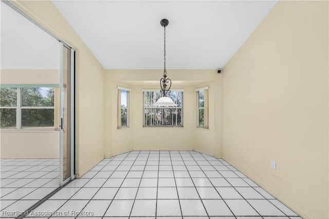 unfurnished dining area featuring light tile patterned flooring