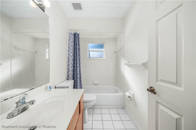 full bathroom featuring tile patterned flooring, vanity, toilet, and shower / tub combo with curtain