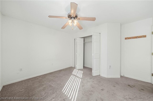 unfurnished bedroom featuring light carpet, a closet, and ceiling fan