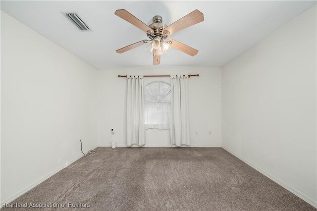 carpeted spare room with ceiling fan