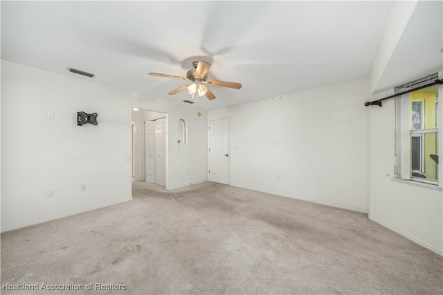 carpeted spare room with ceiling fan