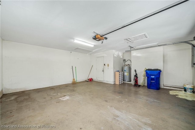 garage featuring a garage door opener and water heater