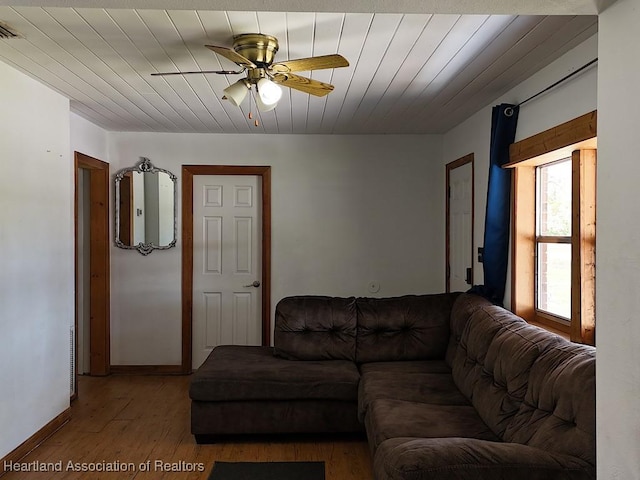 living area featuring wooden ceiling, visible vents, a ceiling fan, and wood finished floors