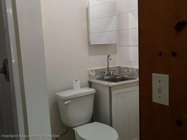 bathroom featuring toilet and vanity