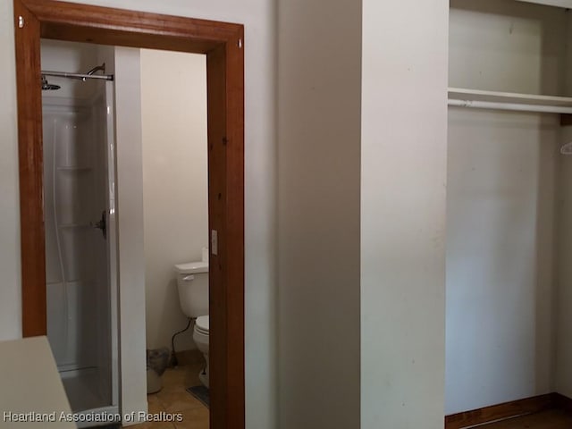 bathroom with a shower and toilet