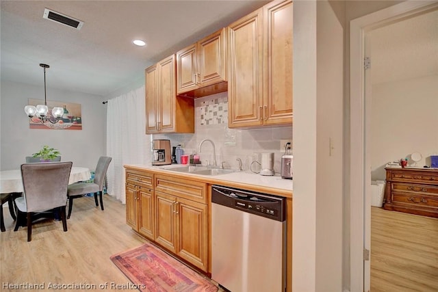 kitchen featuring dishwasher, sink, hanging light fixtures, light hardwood / wood-style floors, and a chandelier