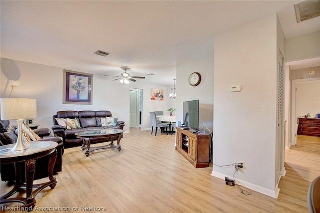 living room featuring light wood-type flooring and ceiling fan