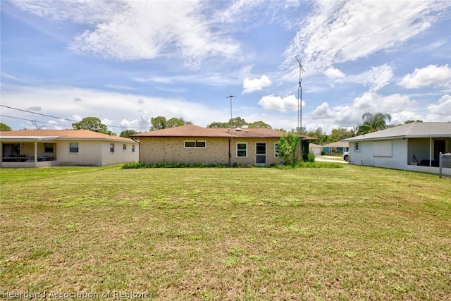 back of property featuring a yard